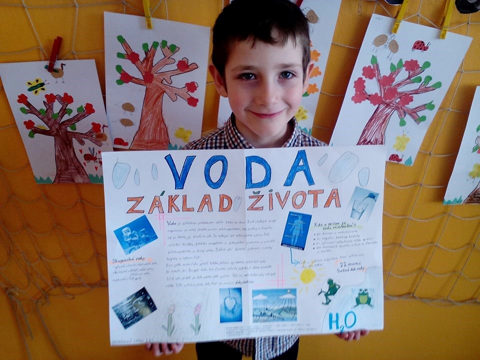 Boy holding paper with his project about water